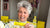 Photo showing Maxine Laceby, a smiling white woman with short grey curly hair, holding up a sachet of Absolute Collagen while taking a selfie and smiling