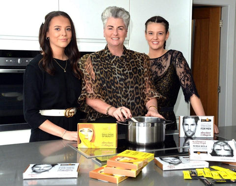 Maxine in the kitchen with her daugthers, Margot and Darcy, and boxes of Absolute Collagen