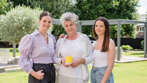 Photo showing Maxine, Margot and Darcy Laceby standing together in a garden and smiling